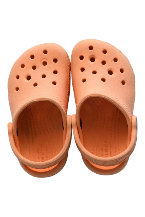 A Orange Slip Ons from Crocs in size 18-24M for girl. (Front View)