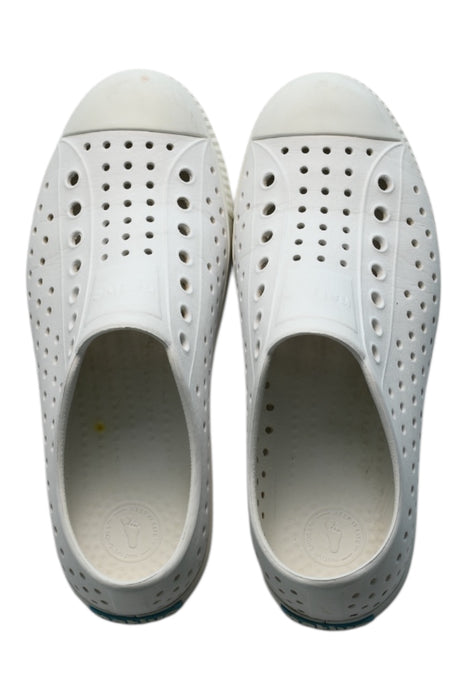 A White Slip Ons from Native Shoes in size 12Y for neutral. (Front View)